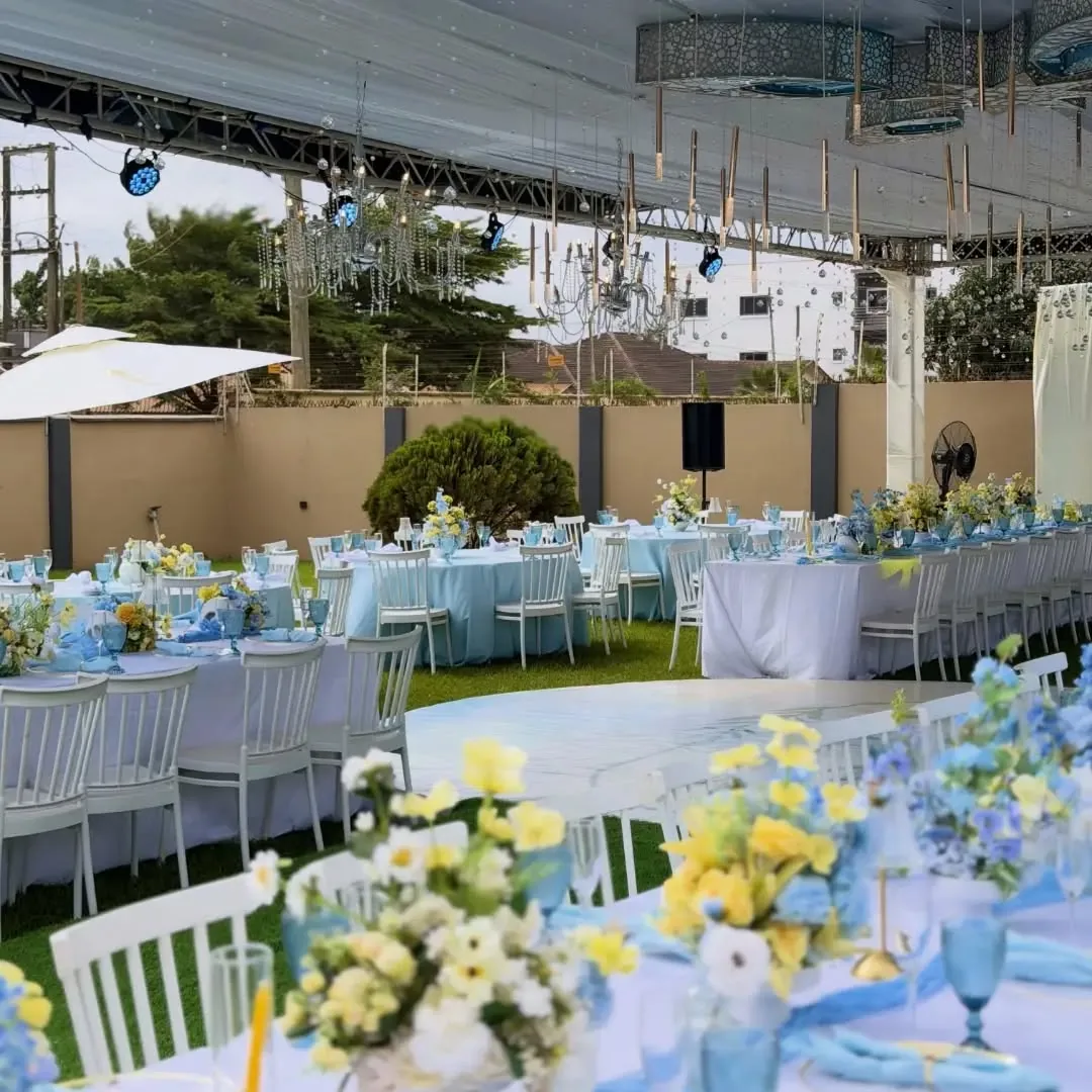 Sky blue and lemon round tables under an outdoor tent