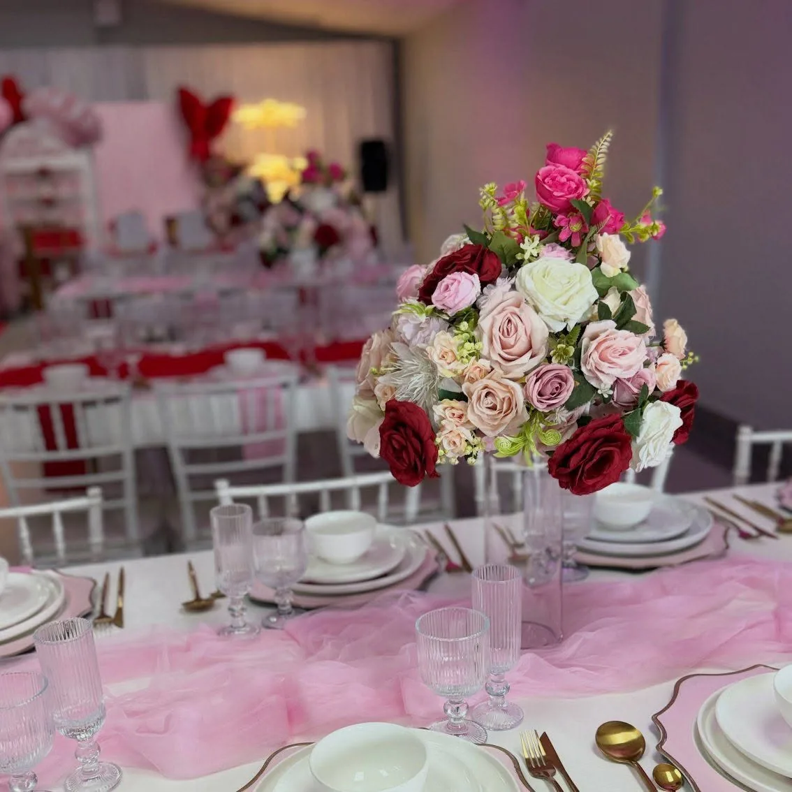 Deep red rose centrepiece on a white table