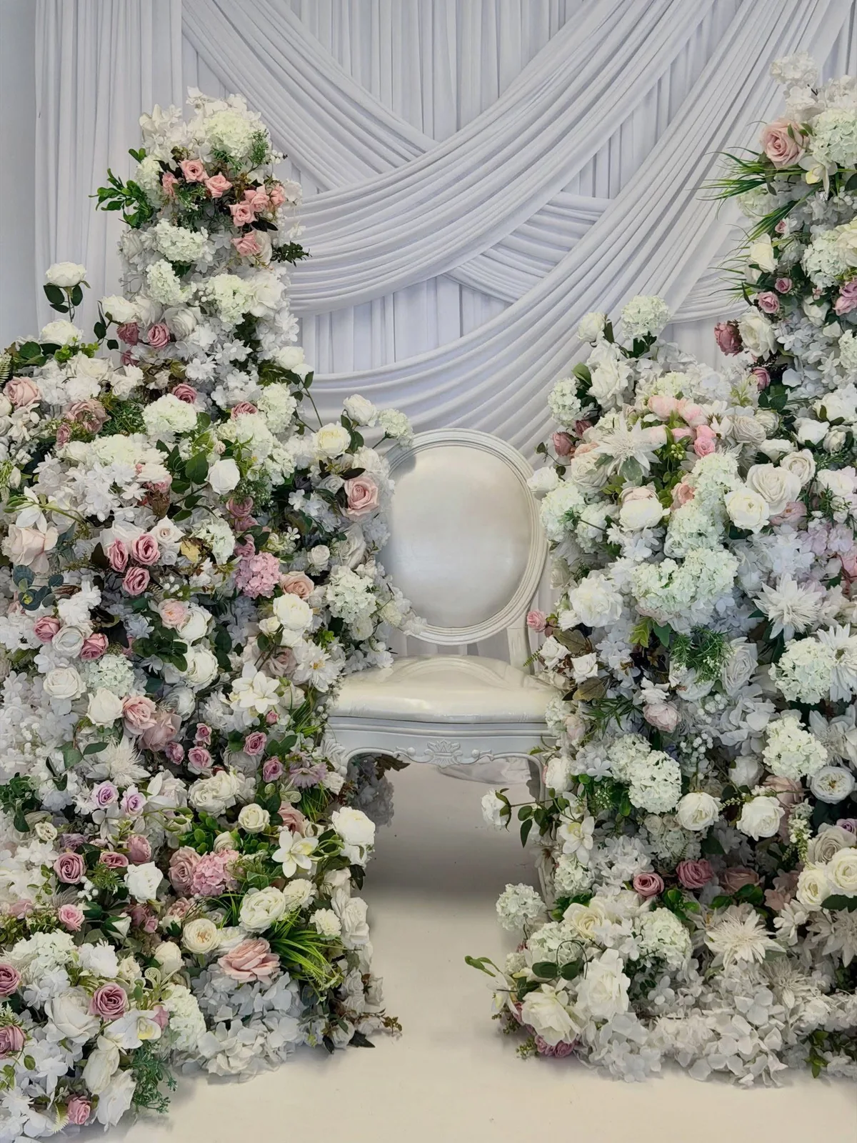 White and blush floral arrangements with a loveseat