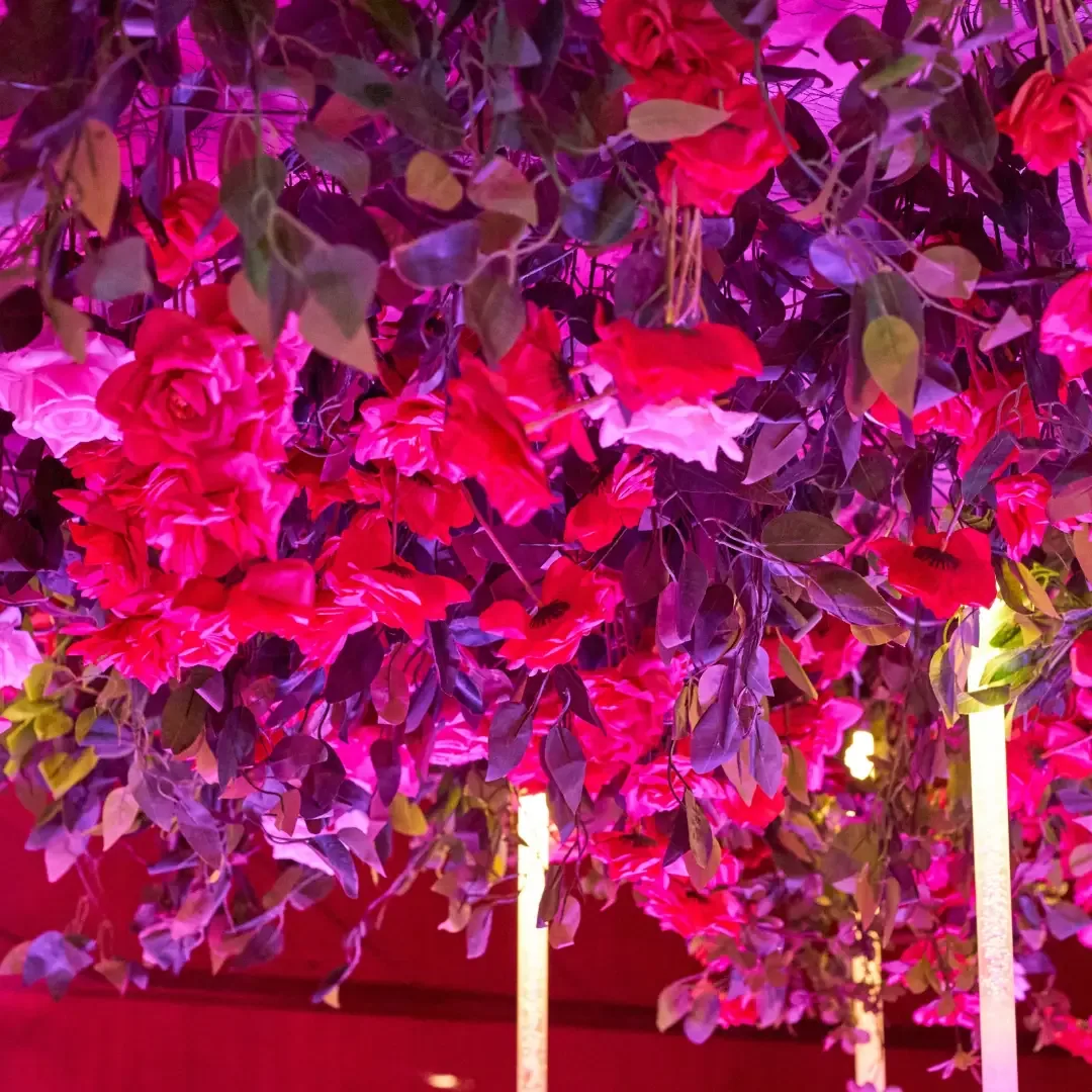 Suspended fuchsia floral ceiling with uplighting by Smartest Decor