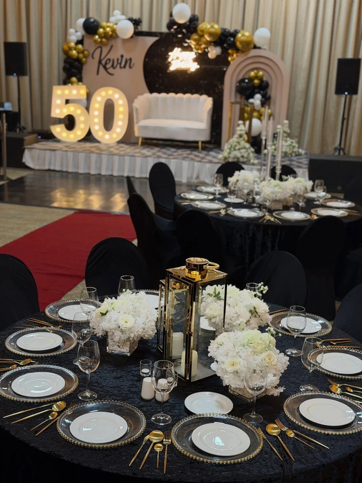 Black and gold 50th birthday tablescape by Smartest Decor