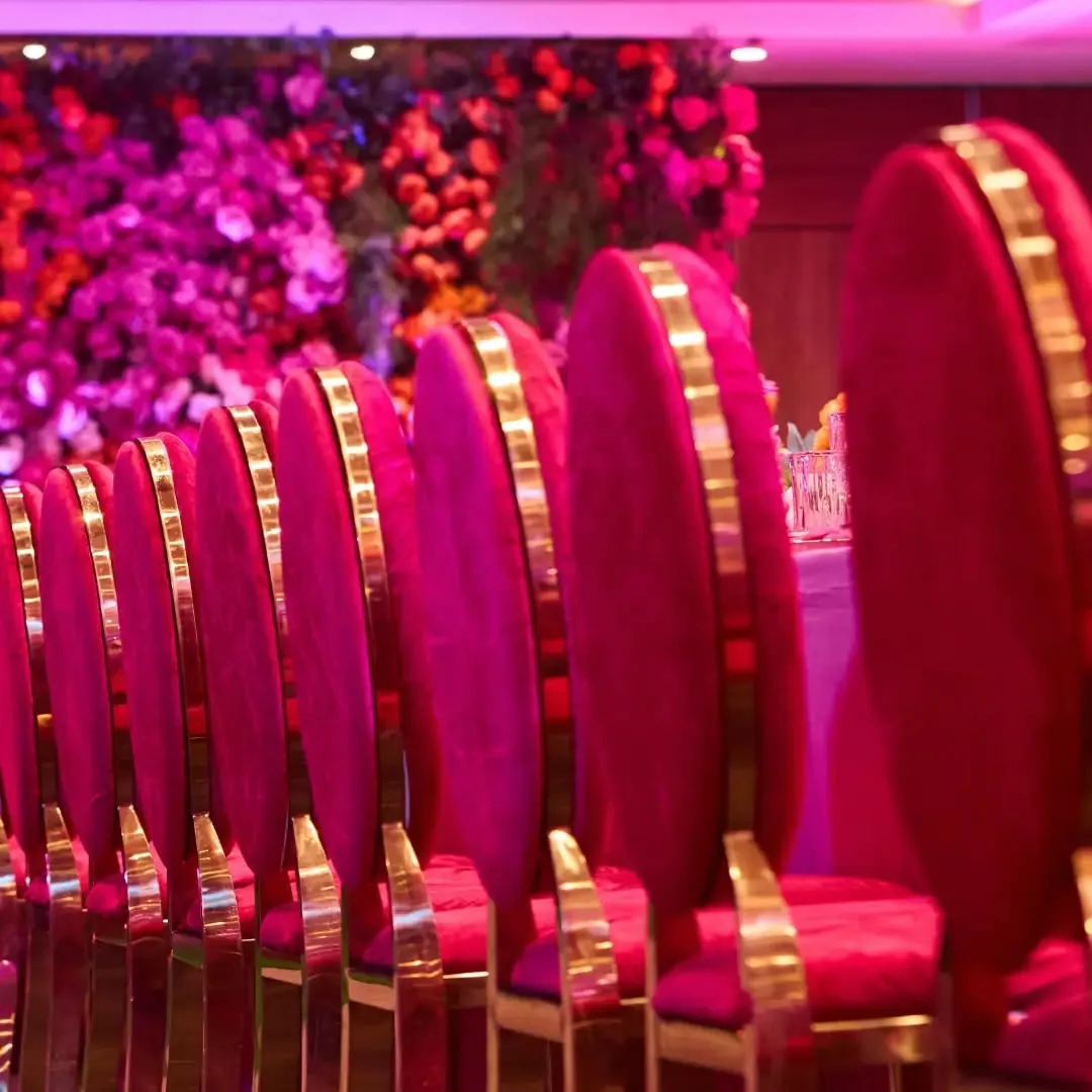 Fuchsia banquet with magenta velvet chairs and gold detailing by Smartest Decor